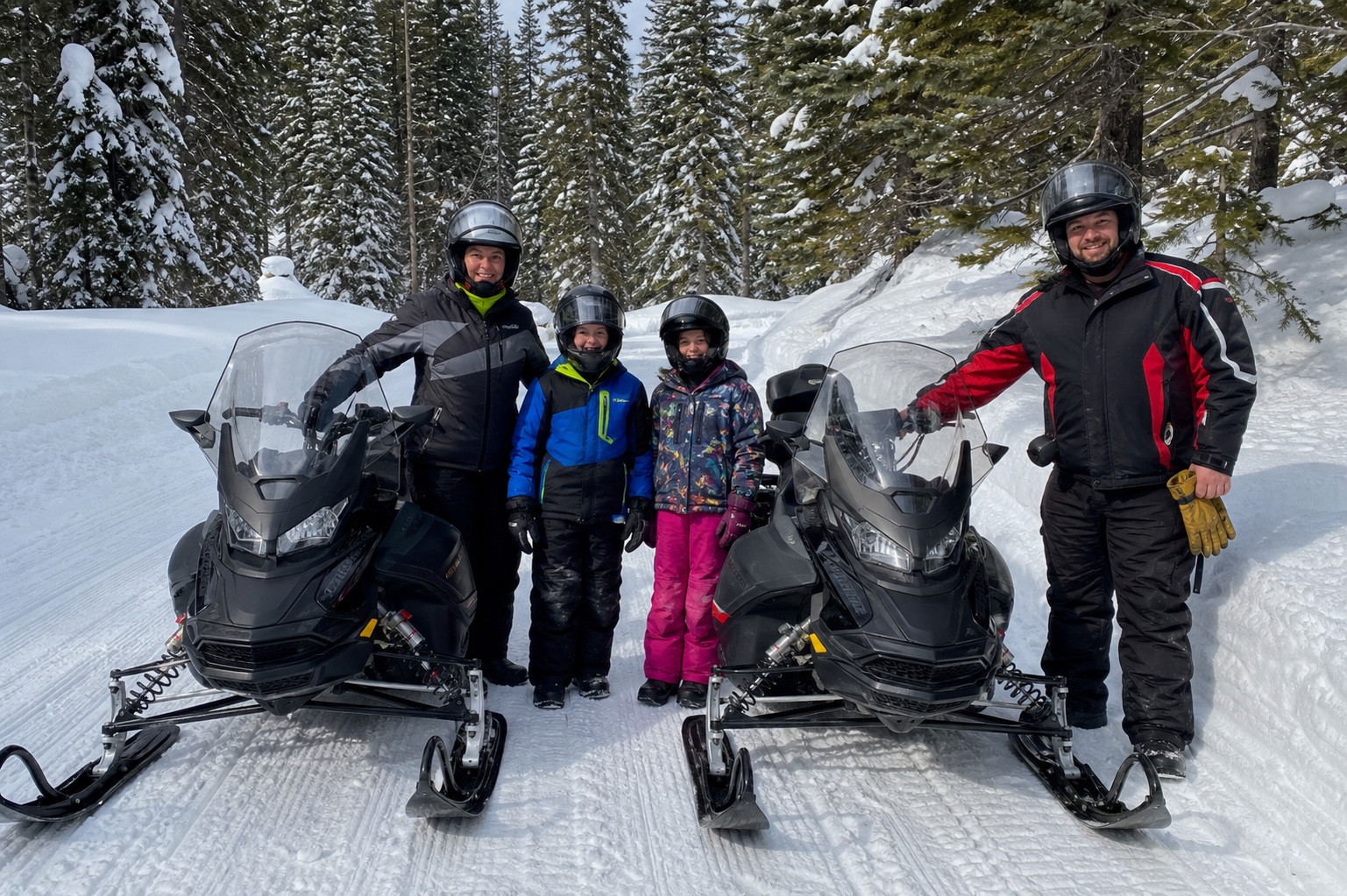 Family with snowmobiles near Mount Shasta